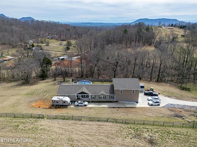 drone / aerial view with a forest view, a rural view, and a mountain view