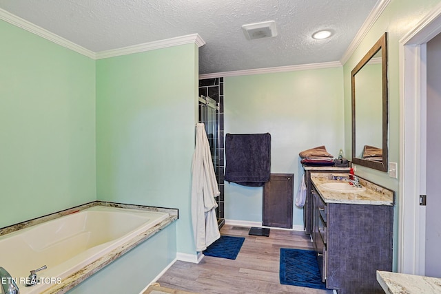 full bath with vanity, wood finished floors, ornamental molding, a shower stall, and a garden tub