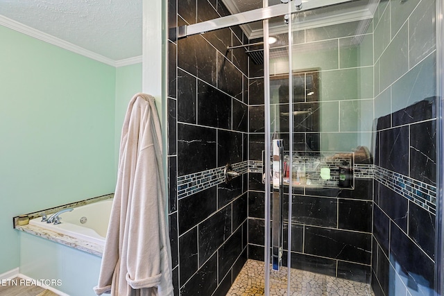 bathroom with crown molding, a bath, a stall shower, and a textured ceiling