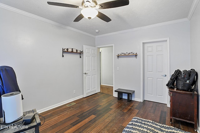 office featuring visible vents, crown molding, dark wood-type flooring, baseboards, and a textured ceiling