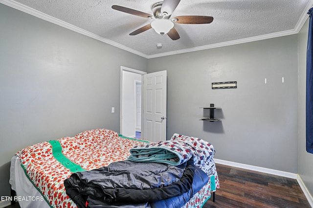 bedroom featuring baseboards, a textured ceiling, wood finished floors, and crown molding