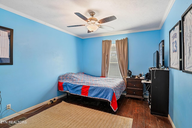 bedroom featuring baseboards, ornamental molding, hardwood / wood-style flooring, a textured ceiling, and a ceiling fan