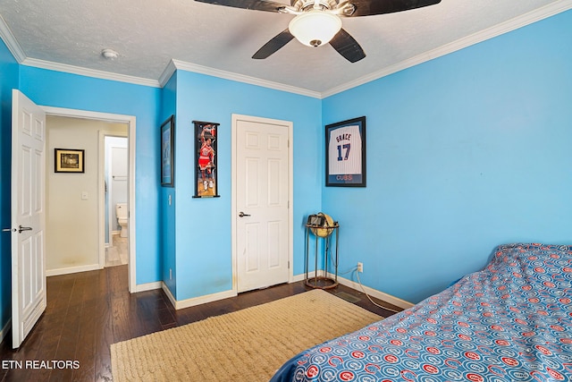 bedroom featuring dark wood-type flooring, ornamental molding, a textured ceiling, baseboards, and ceiling fan