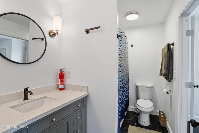 full bath with baseboards, toilet, vanity, and tile patterned flooring