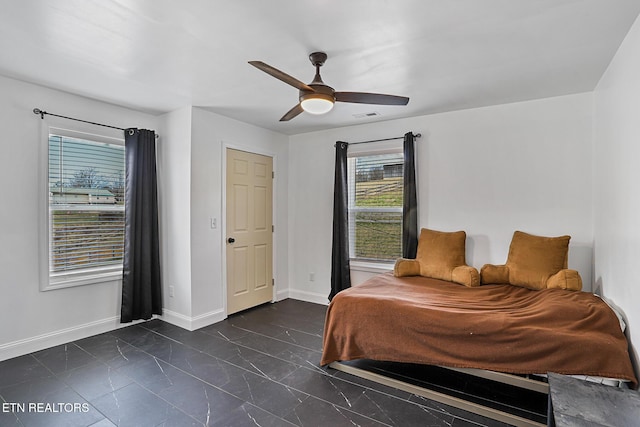 bedroom with visible vents, baseboards, marble finish floor, and ceiling fan