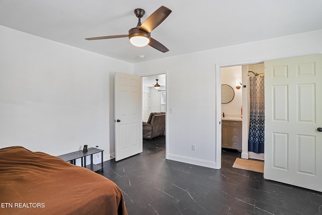 bedroom featuring connected bathroom, a ceiling fan, and baseboards