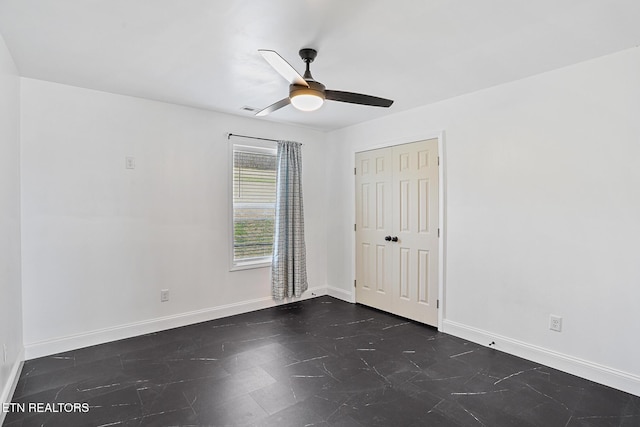 unfurnished bedroom featuring a closet, baseboards, visible vents, and ceiling fan