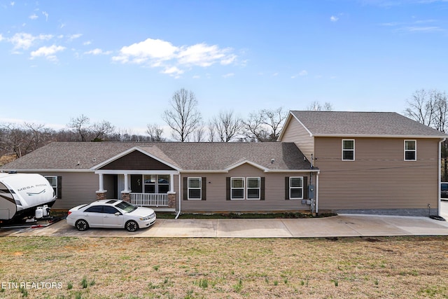 exterior space featuring a front yard and roof with shingles