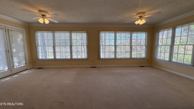 spare room featuring crown molding, carpet flooring, and ceiling fan