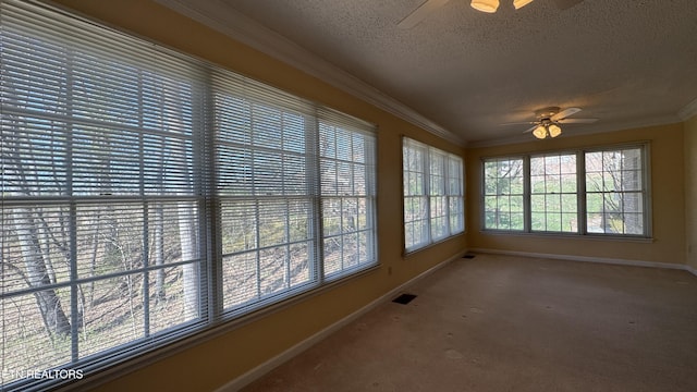 unfurnished sunroom with visible vents and ceiling fan