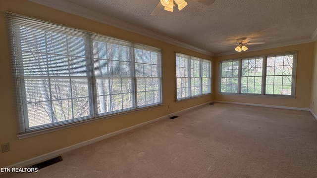 unfurnished sunroom with visible vents, a healthy amount of sunlight, and ceiling fan