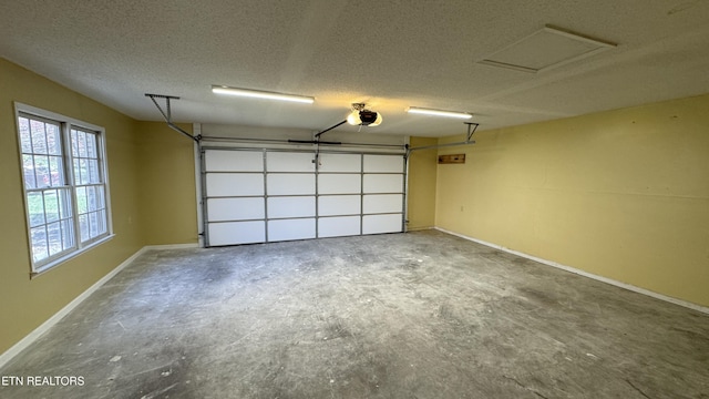 garage with a garage door opener and baseboards