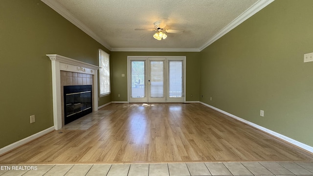 unfurnished living room featuring crown molding, a textured ceiling, and light wood-type flooring