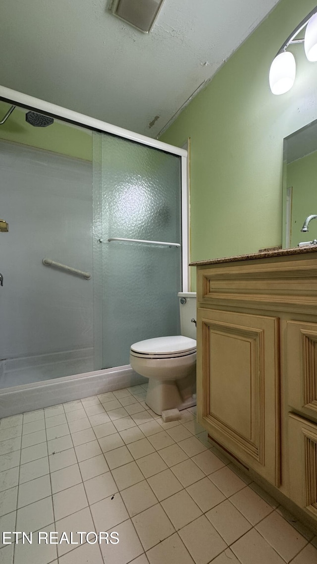 full bath with tile patterned floors, visible vents, toilet, a shower stall, and vanity