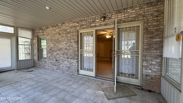 view of exterior entry with brick siding