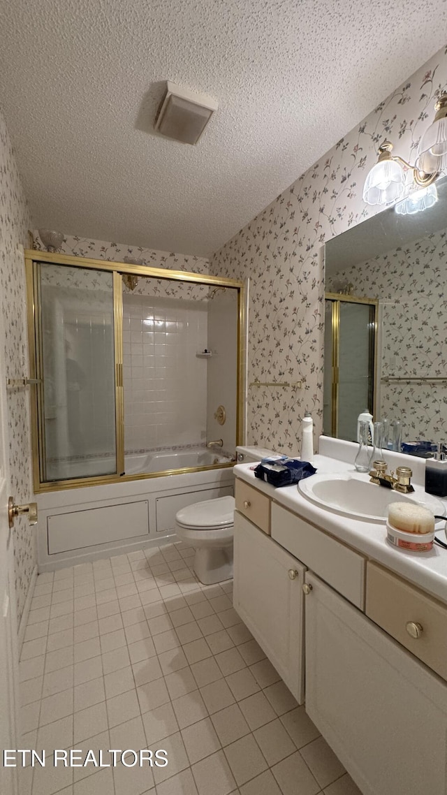 bathroom featuring wallpapered walls, toilet, vanity, shower / bath combination with glass door, and a textured ceiling