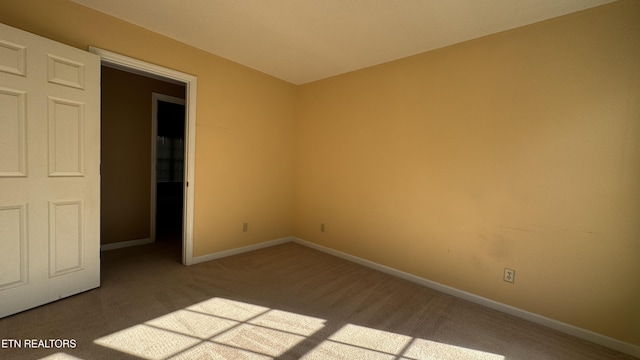 unfurnished bedroom featuring carpet and baseboards