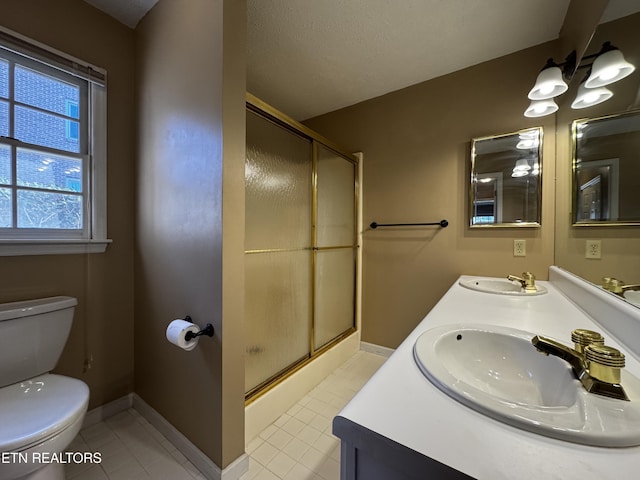 bathroom with toilet, a sink, and a stall shower