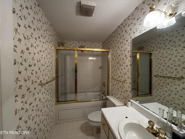 full bath featuring a textured ceiling, combined bath / shower with glass door, wallpapered walls, toilet, and tile patterned flooring