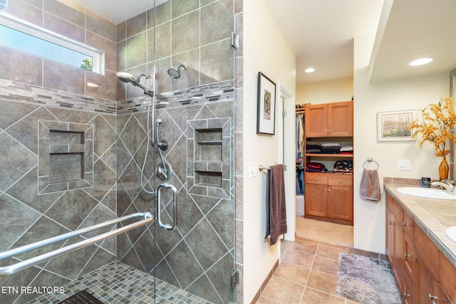 bathroom with vanity, recessed lighting, a stall shower, tile patterned flooring, and a walk in closet