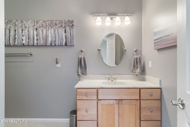 bathroom with vanity and baseboards