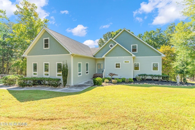 back of property with a lawn