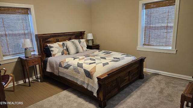 bedroom featuring carpet flooring and baseboards