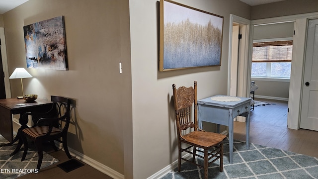 interior space featuring wood finished floors and baseboards