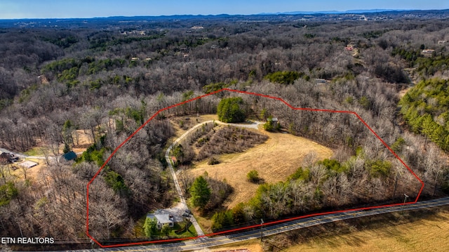 bird's eye view featuring a wooded view