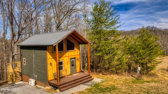 view of outdoor structure with a wooded view