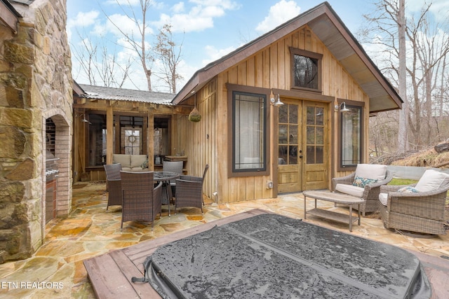 exterior space featuring outdoor dining area, outdoor lounge area, and french doors