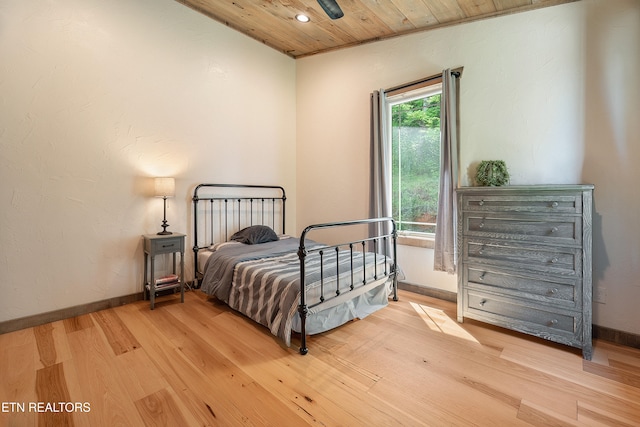 bedroom with recessed lighting, baseboards, light wood-style flooring, and wooden ceiling