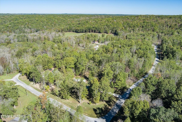 birds eye view of property with a view of trees