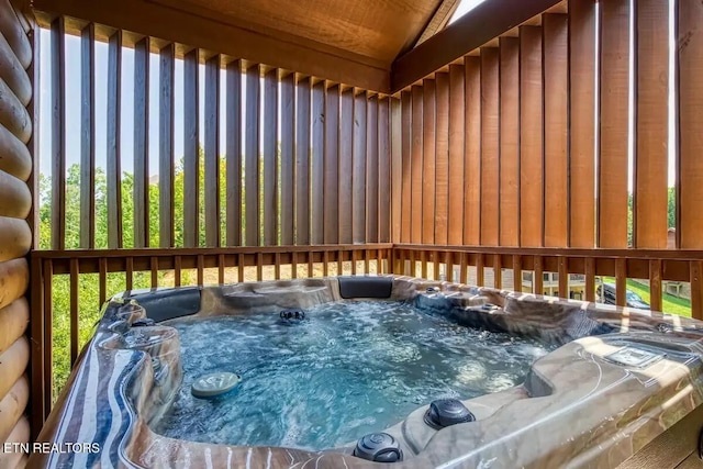 wooden terrace featuring a hot tub