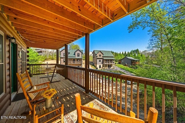 view of wooden balcony with a residential view and a deck