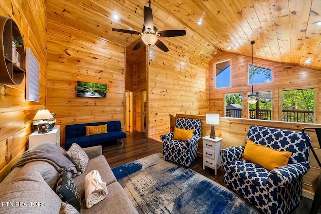 living room featuring wooden walls, a ceiling fan, wood finished floors, high vaulted ceiling, and wooden ceiling