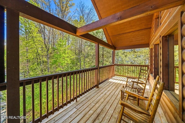 wooden deck featuring a view of trees