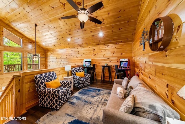 living area featuring wooden walls, wood finished floors, ceiling fan, vaulted ceiling, and wooden ceiling