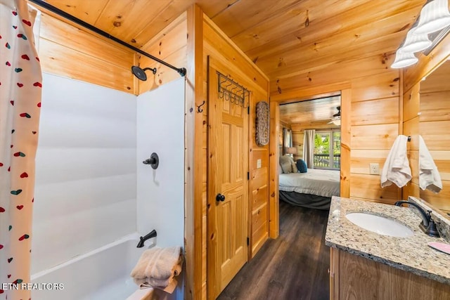 full bath with vanity, wooden walls, wood finished floors, shower / bath combination with curtain, and wooden ceiling