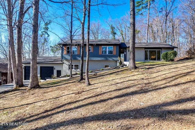 view of front of property featuring a garage and brick siding