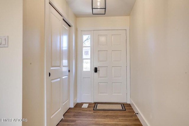 entryway featuring baseboards and wood finished floors