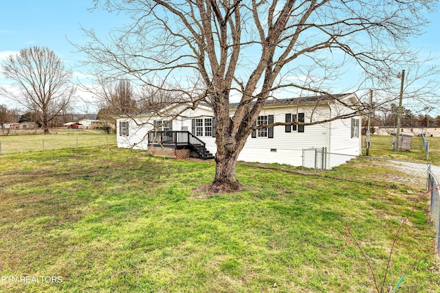 back of house featuring a yard, fence, and crawl space