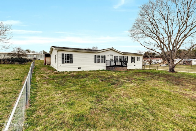 rear view of house with a wooden deck, a yard, a fenced backyard, and crawl space