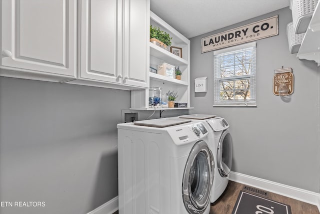 clothes washing area featuring washer and dryer, baseboards, cabinet space, and dark wood-type flooring