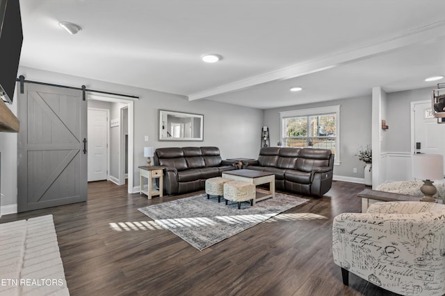 living area featuring beam ceiling, dark wood-style floors, baseboards, and a barn door