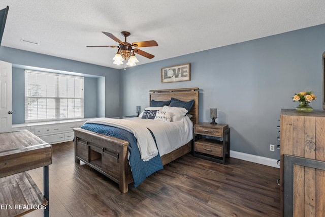 bedroom featuring visible vents, ceiling fan, baseboards, a textured ceiling, and dark wood-style flooring