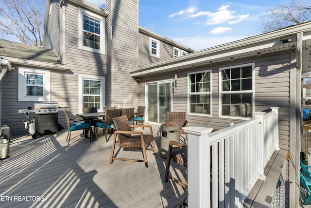 wooden terrace featuring a grill