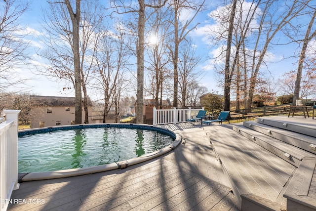 outdoor pool featuring a deck