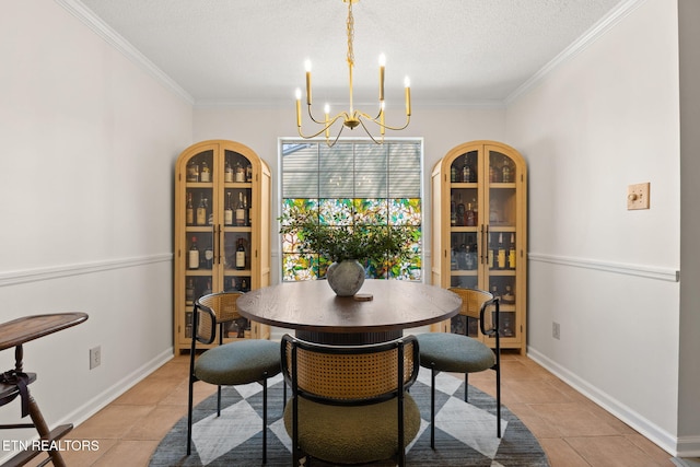 dining space with light tile patterned floors, a chandelier, a textured ceiling, and baseboards