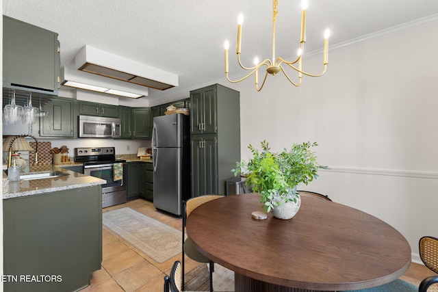 dining space featuring light tile patterned flooring, a notable chandelier, a textured ceiling, and ornamental molding